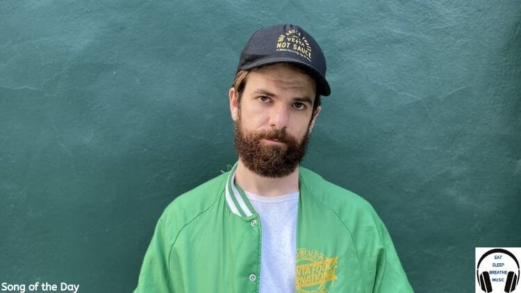 Black Nash White Man with a Beard wearing a Green Jacket and Hat Against A blue wall | Song of the Day "Alligator" by BlackNash| Eat Sleep Breathe Music