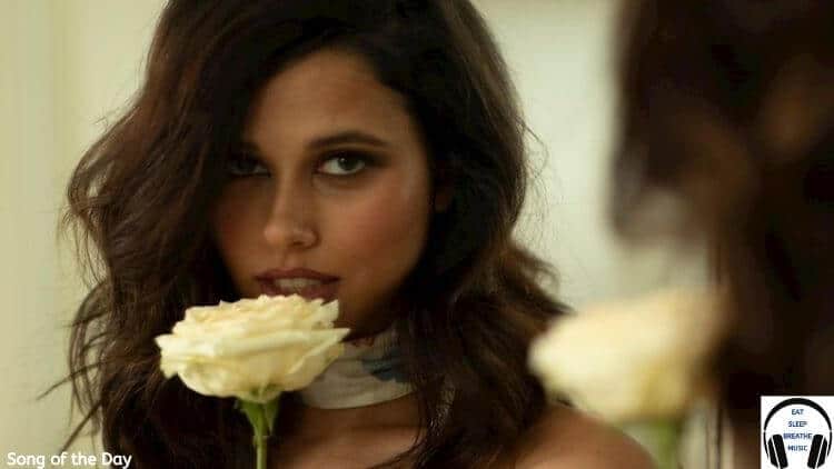 White woman with brown hair smelling a white flower | Kaleigh "Weather the storm" Song of the Day FEature | Eat Sleep Breathe Music