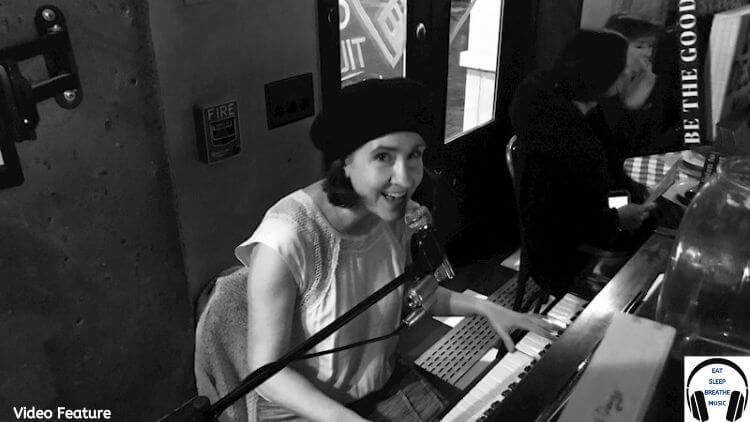 White woman at a keyboard with a microphone |Lyndol Descant "Let It All Krumble" Video| Eat Sleep Breathe Music