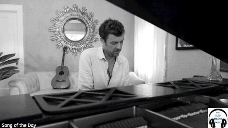 White Man playing a piano in a white shirt black and white photo | jefff Song of the day feature | Eat Sleep Breathe Music