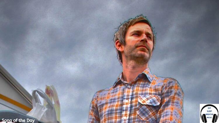 White Man wearing a plaid shirt standing in front of a grey sky | My Favorite Mixtap Song of the Day Feature | Eat Sleep Breathe Music