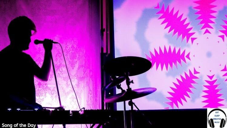 silhouette of a man at a keyboard with a microphone and pink background | Jobbaloon Song of the Day Feature | Eat Sleep Breathe Music