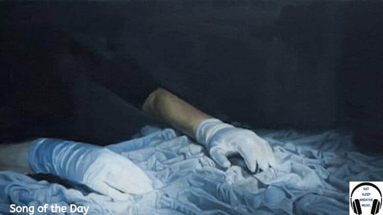 Picture of a person's arms covered in gloves on a white table cloth Tawni Bias Song of the Day Feature | Eat Sleep Breathe Music