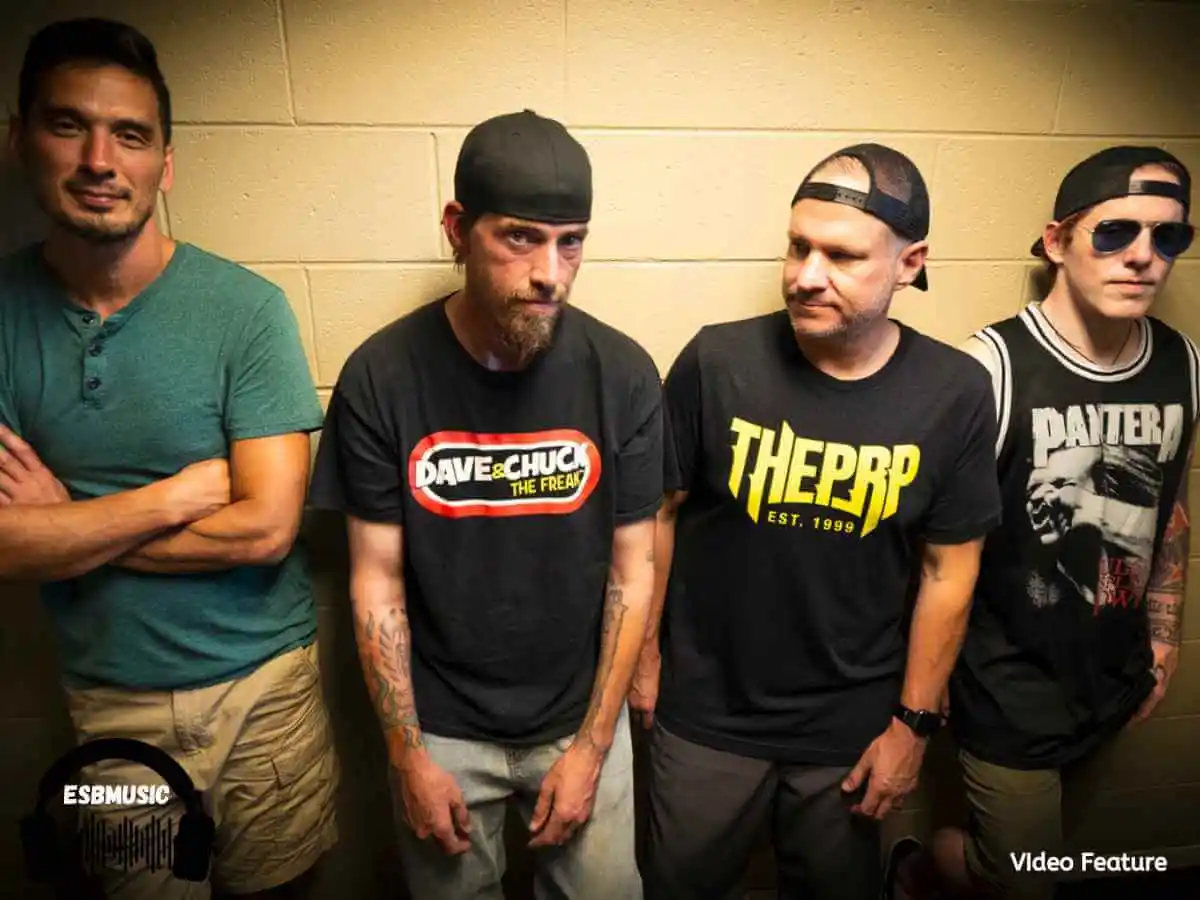 The members of Taproot standing against a yellow cinderblock wall | Eat Sleep Breathe Music